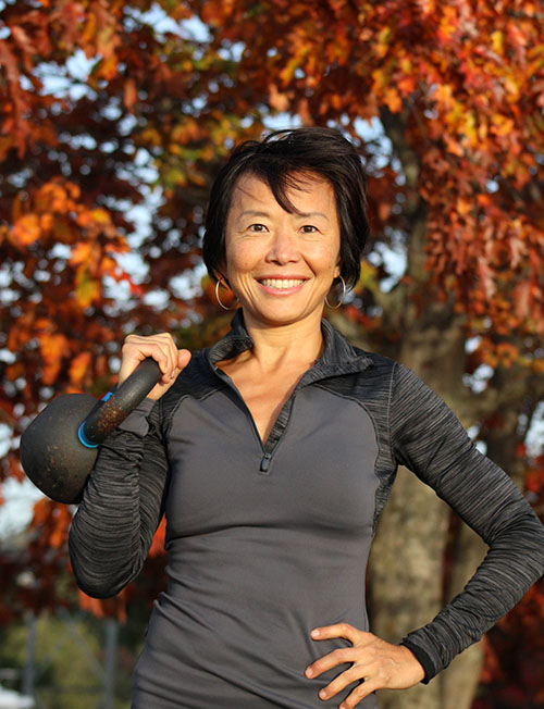 Connie with kettlebell and fall foliage Connie with kettlebell and fall foliage