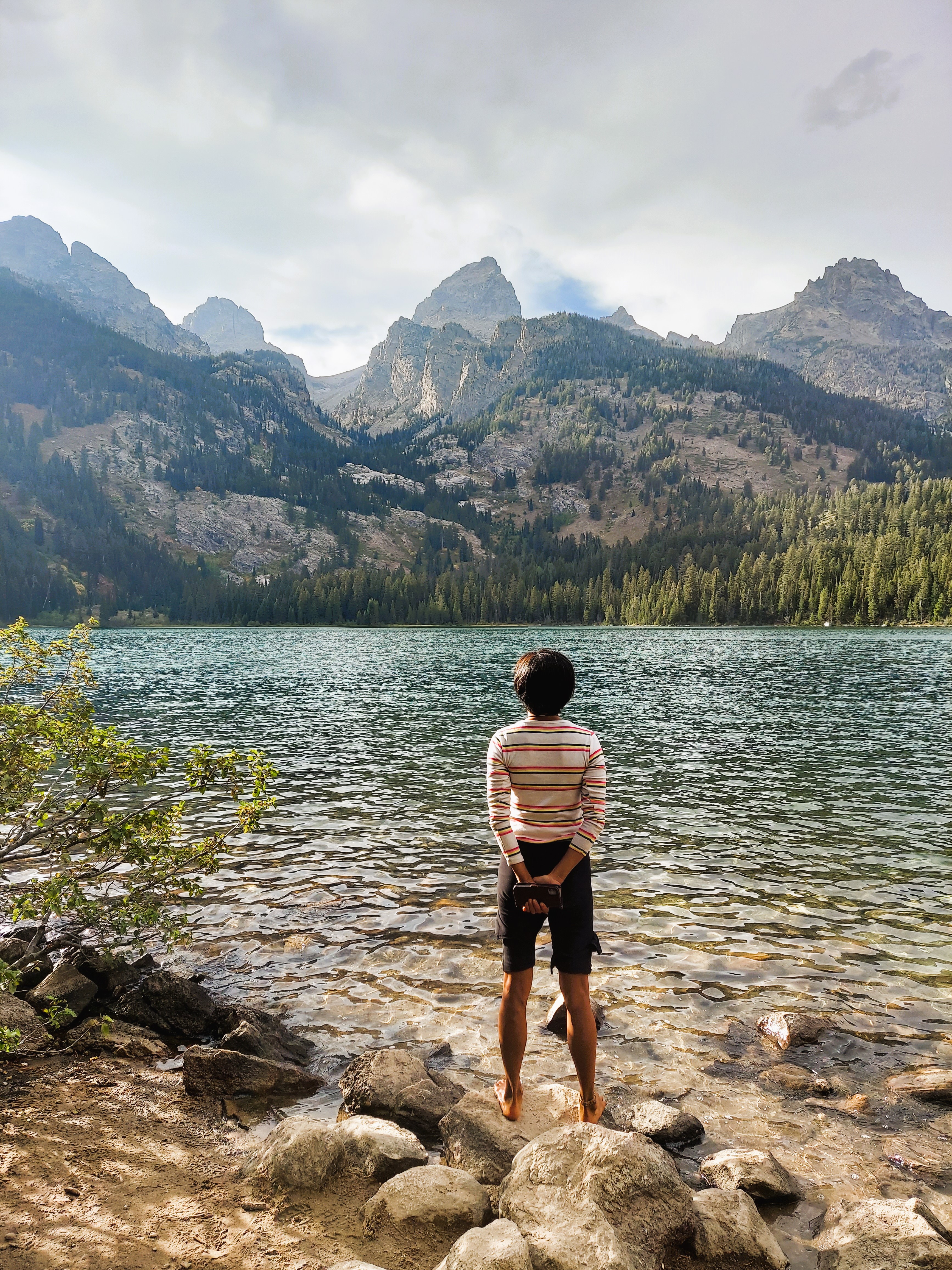 A woman looking over a mountain lake
